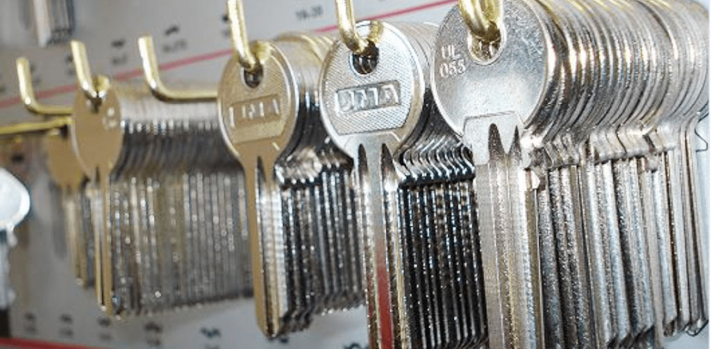 Lots of yale lock keys hanging on a board